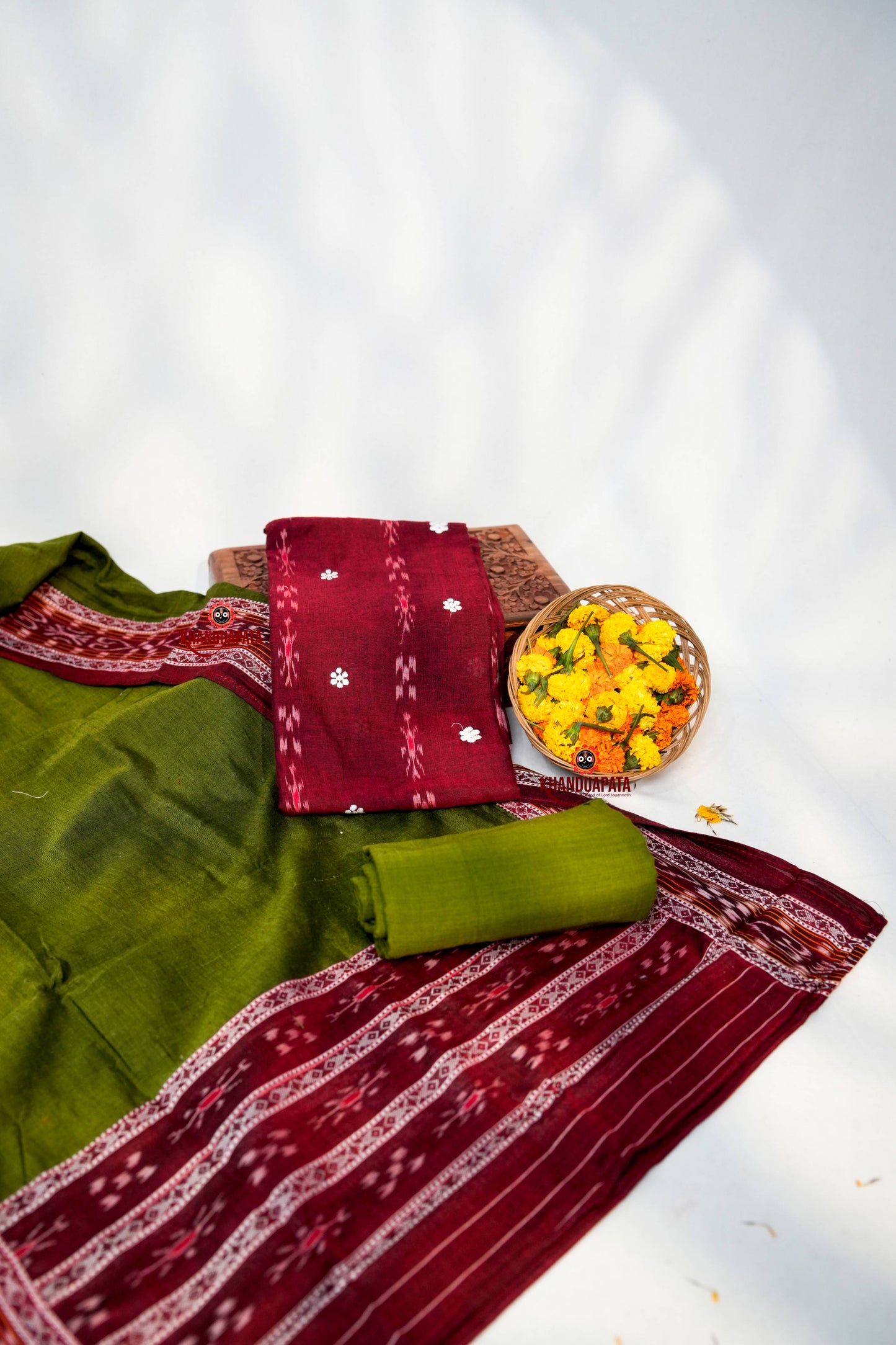 Traditional saree with a basket of flowers on a white background