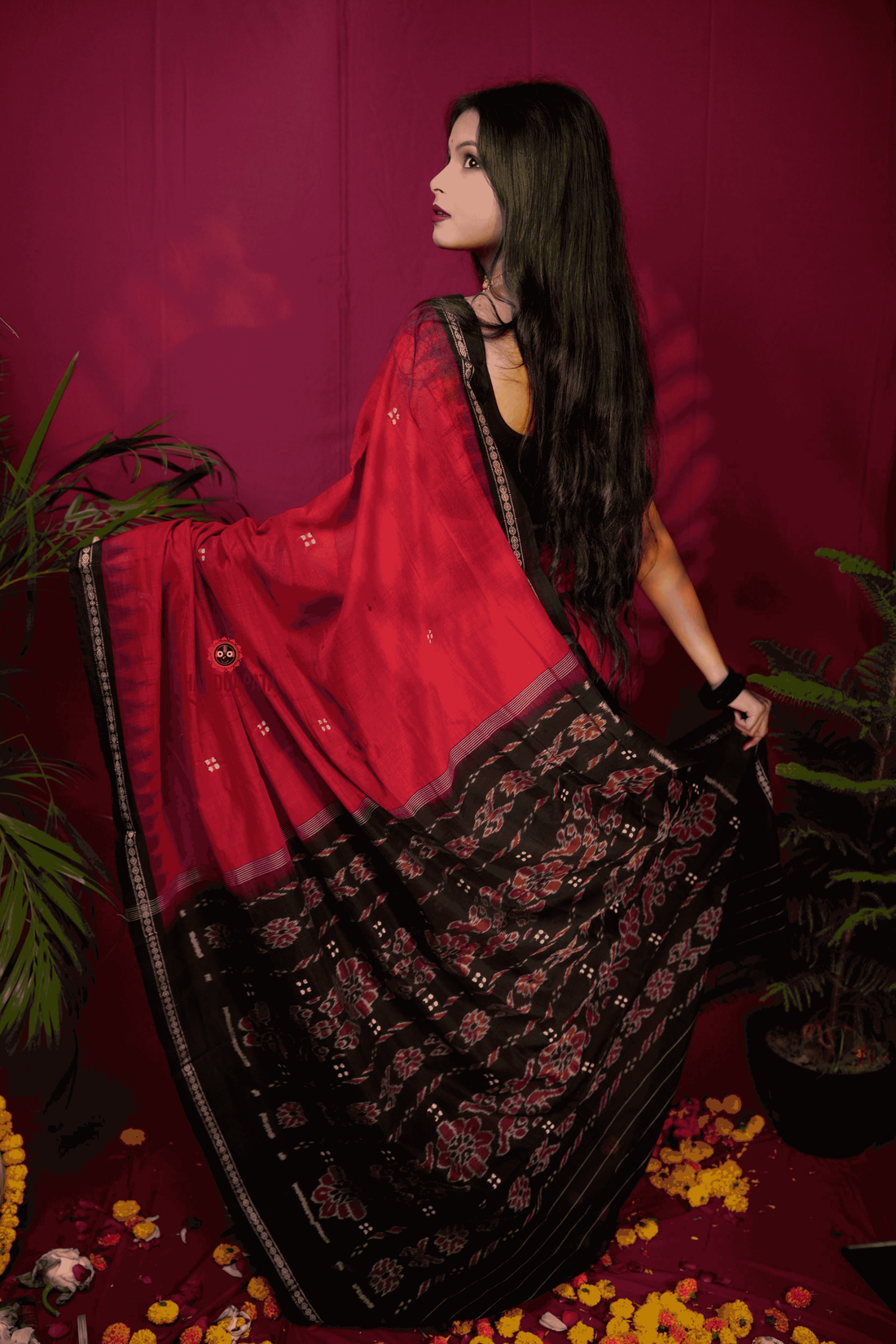 Woman adjusting handwoven cotton saree outdoors