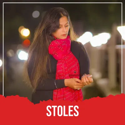 Model wearing red handloom stole with traditional patterns