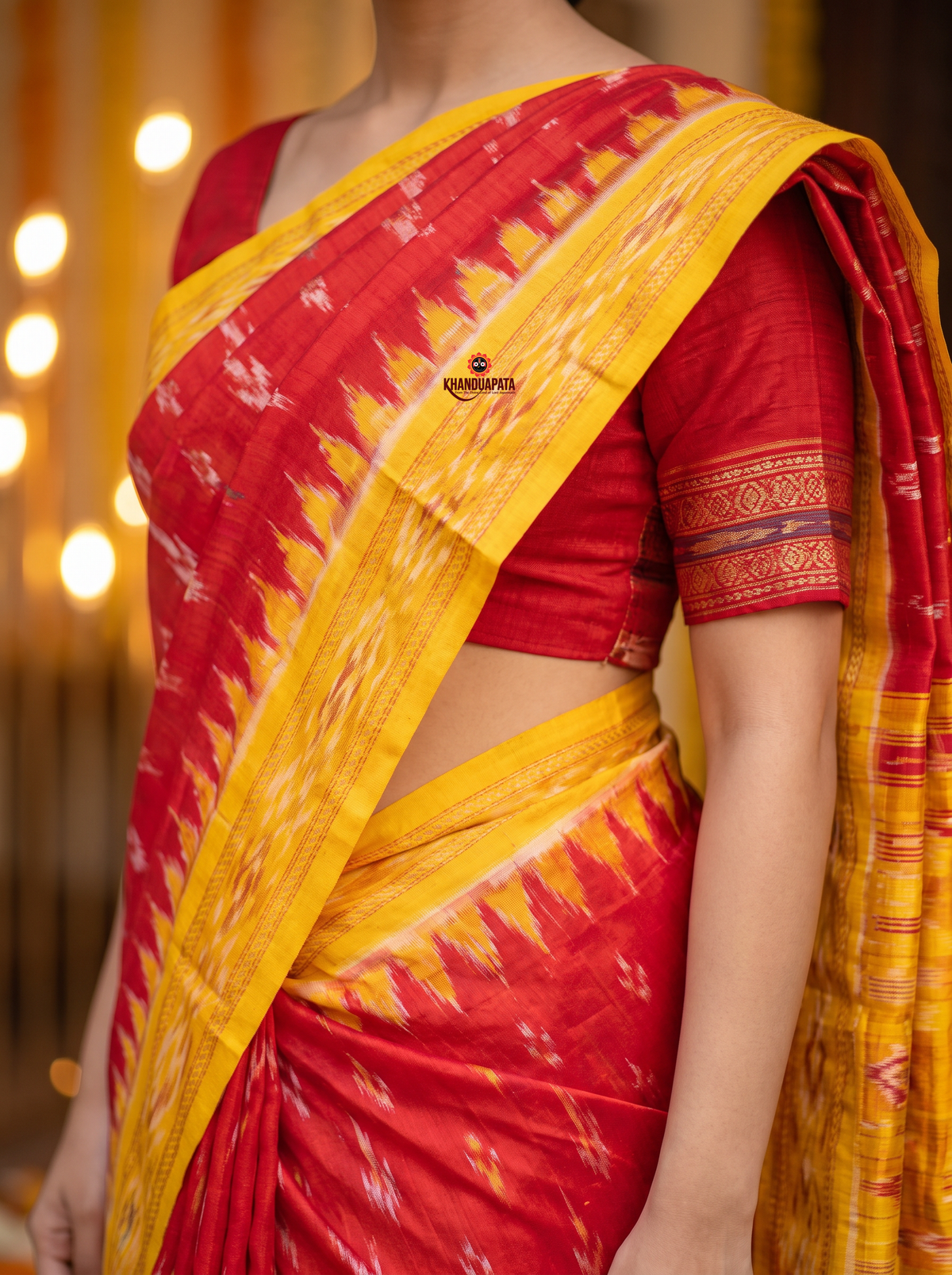 Red and bright yellow colour traditional Ikat design silk saree by Khanduapata - styled view