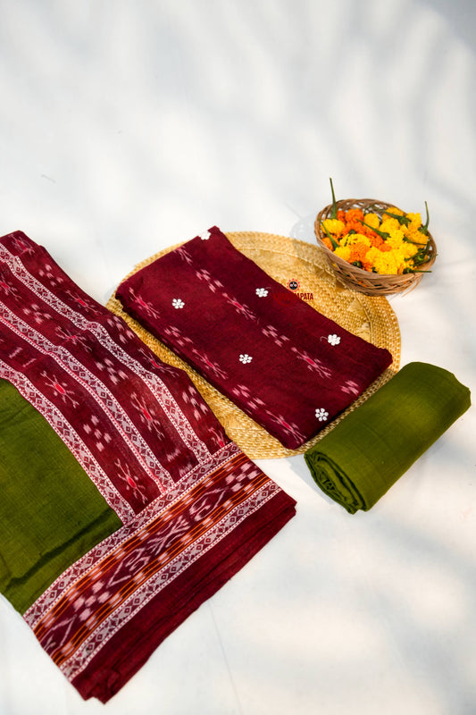 Traditional fabric with intricate patterns on a woven mat and basket with flowers.