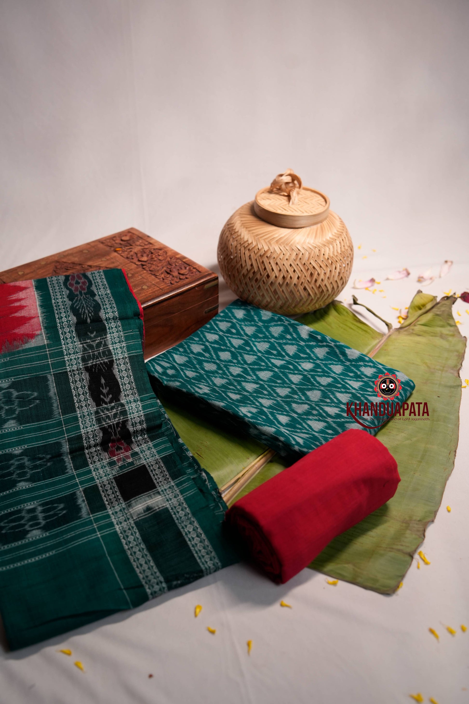 Traditional fabric with patterns and a woven container on a light background