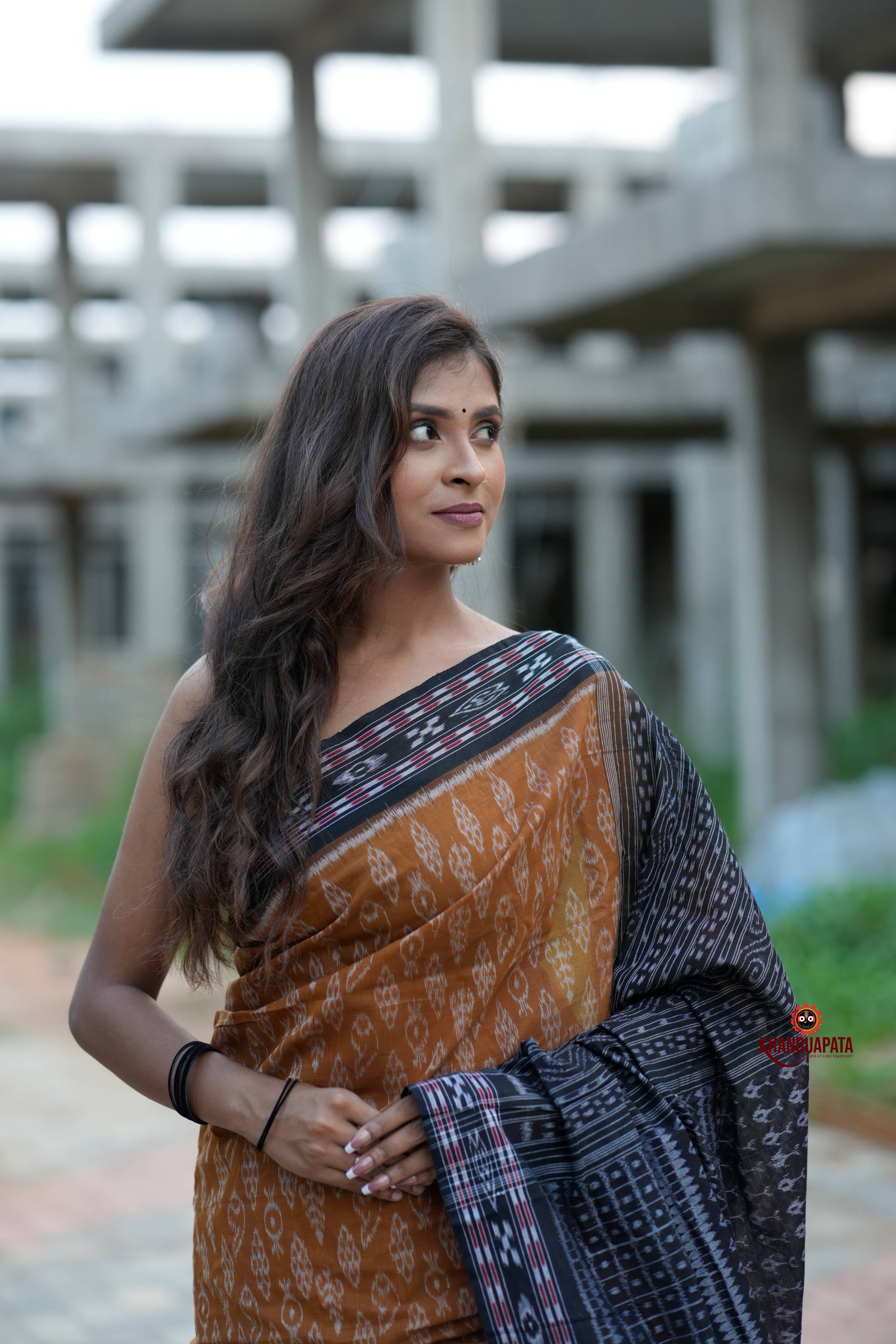 Woman wearing a traditional saree with a blurred background