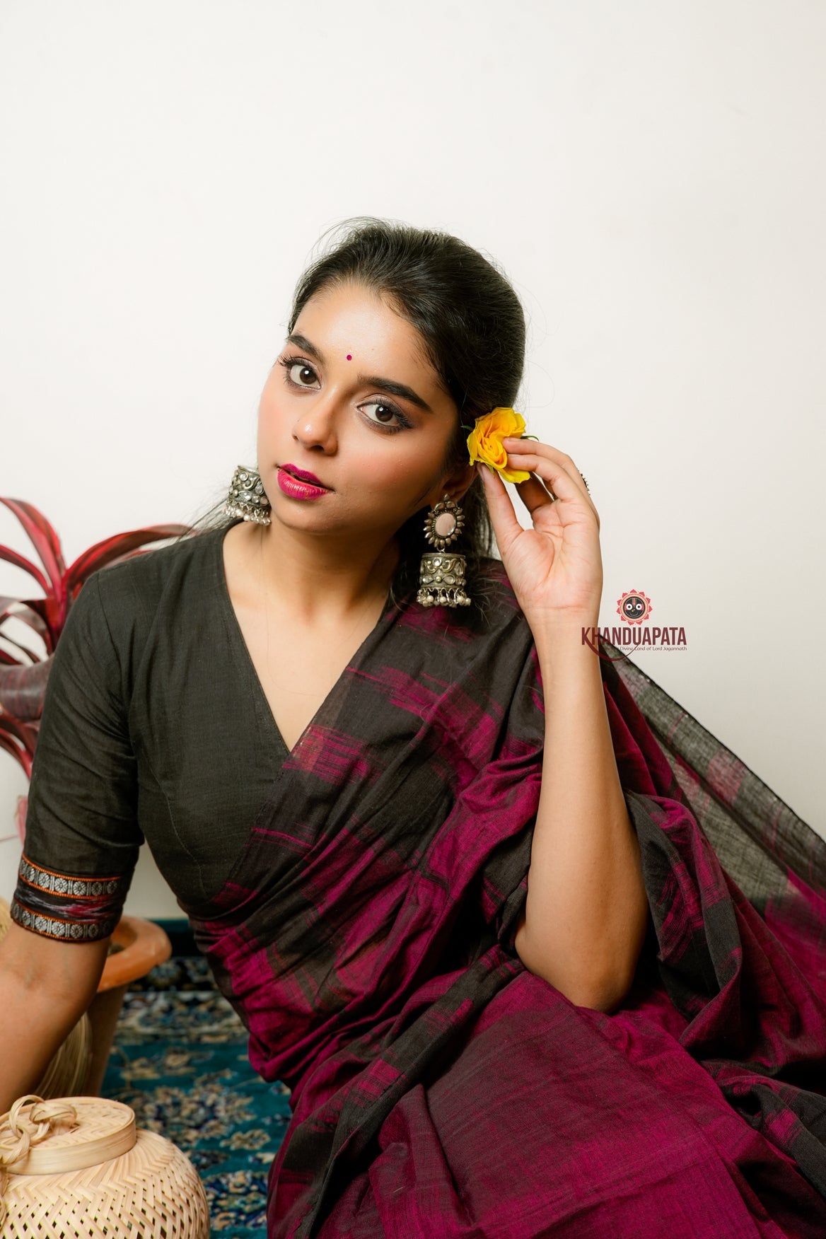 Woman in a dark saree with a white background