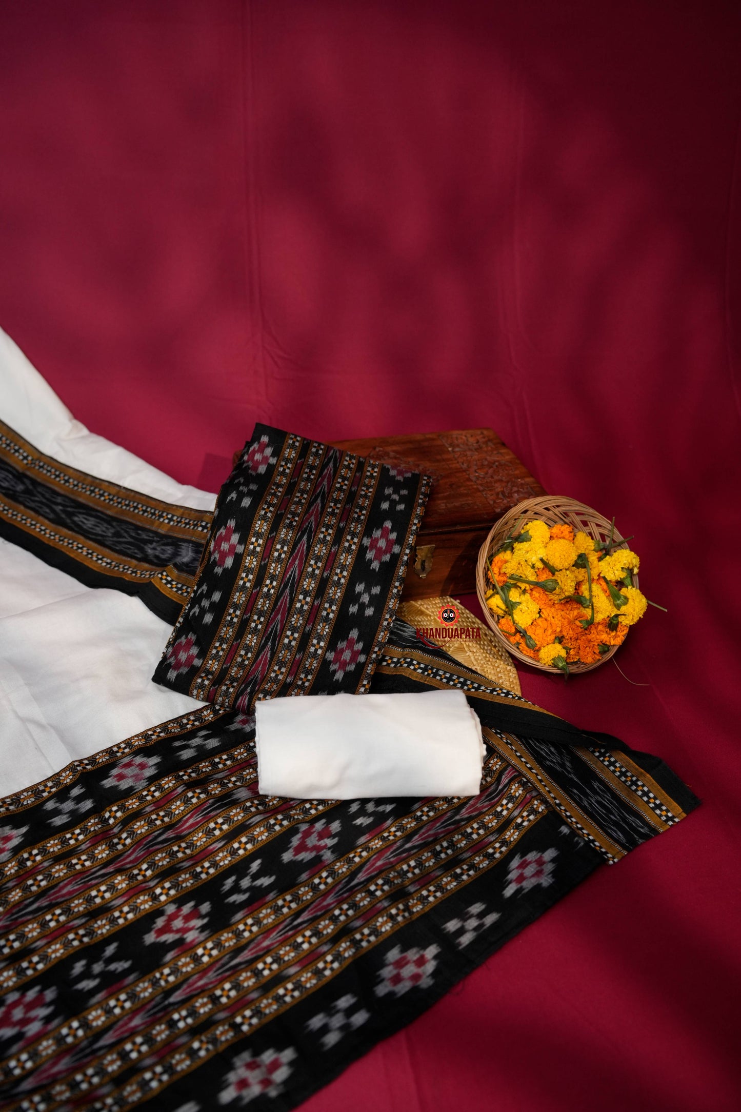 Traditional fabric with intricate patterns on a red background