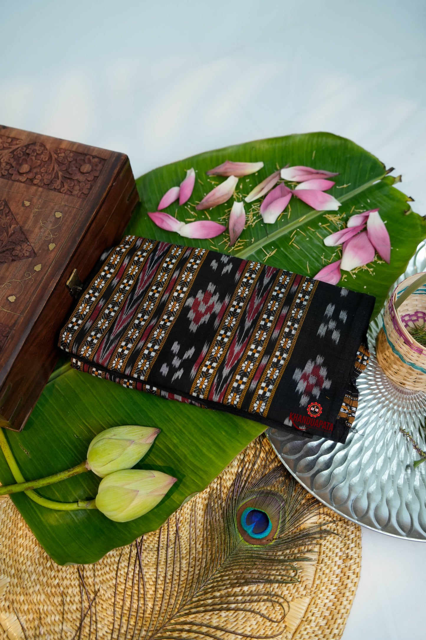 Decorative Stole with intricate patterns on a leaf with flowers and a wooden box.