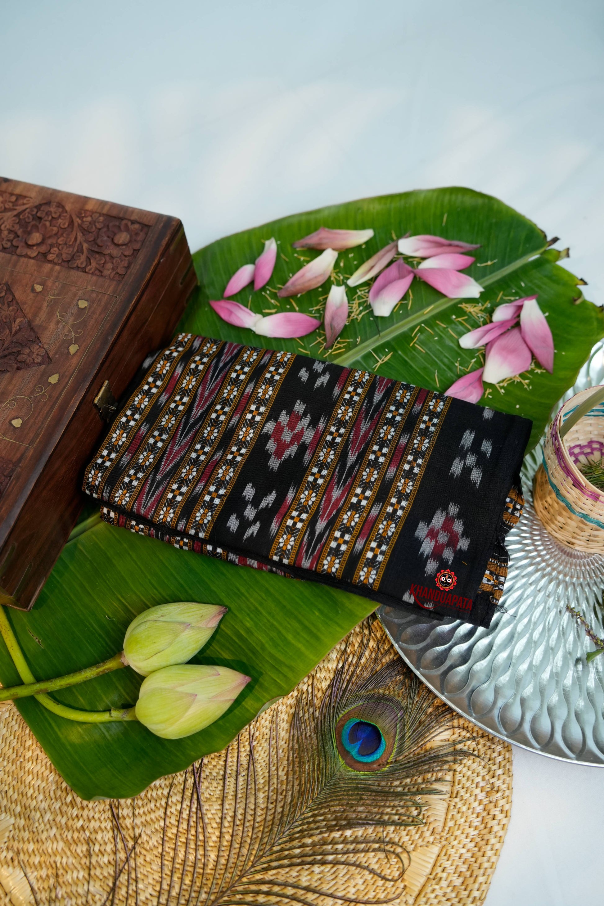 Decorative Stole with intricate patterns on a leaf with flowers and a wooden box.